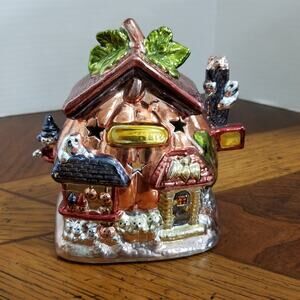 Two halloween ceramic tealight holders shaped like a pumpkin house